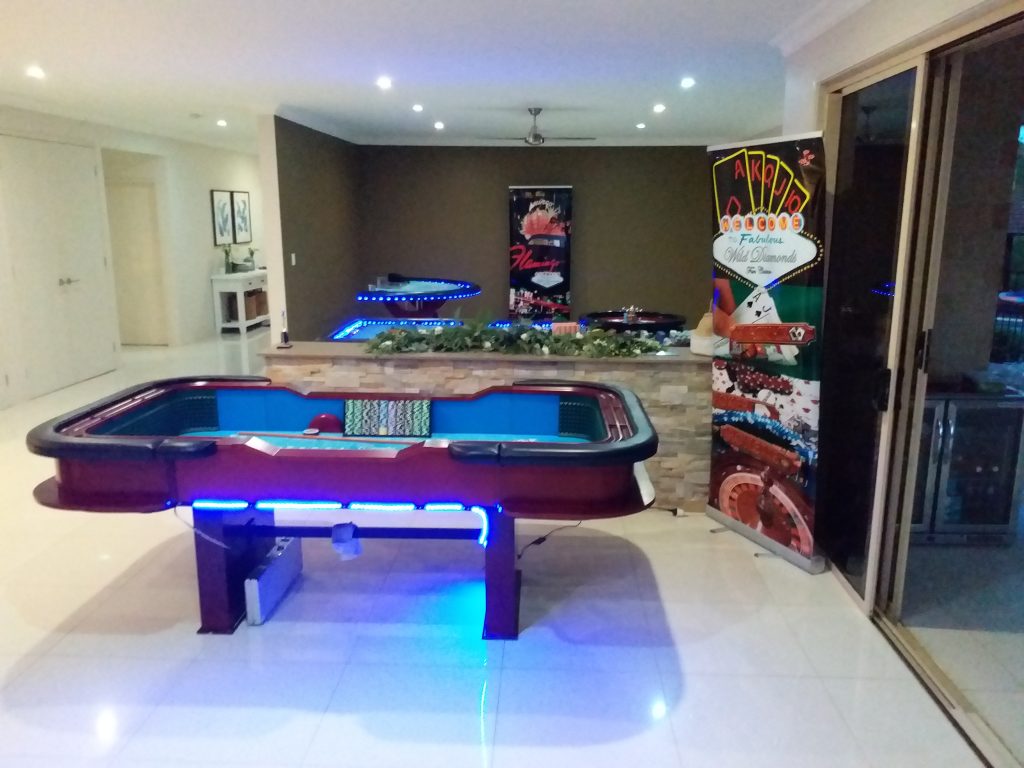 Casino gaming room setup by Wild Diamonds Fun Casino Brisbane - Professional casino table with LED lighting and themed decorations for Sunshine Coast and Brisbane home and venue events