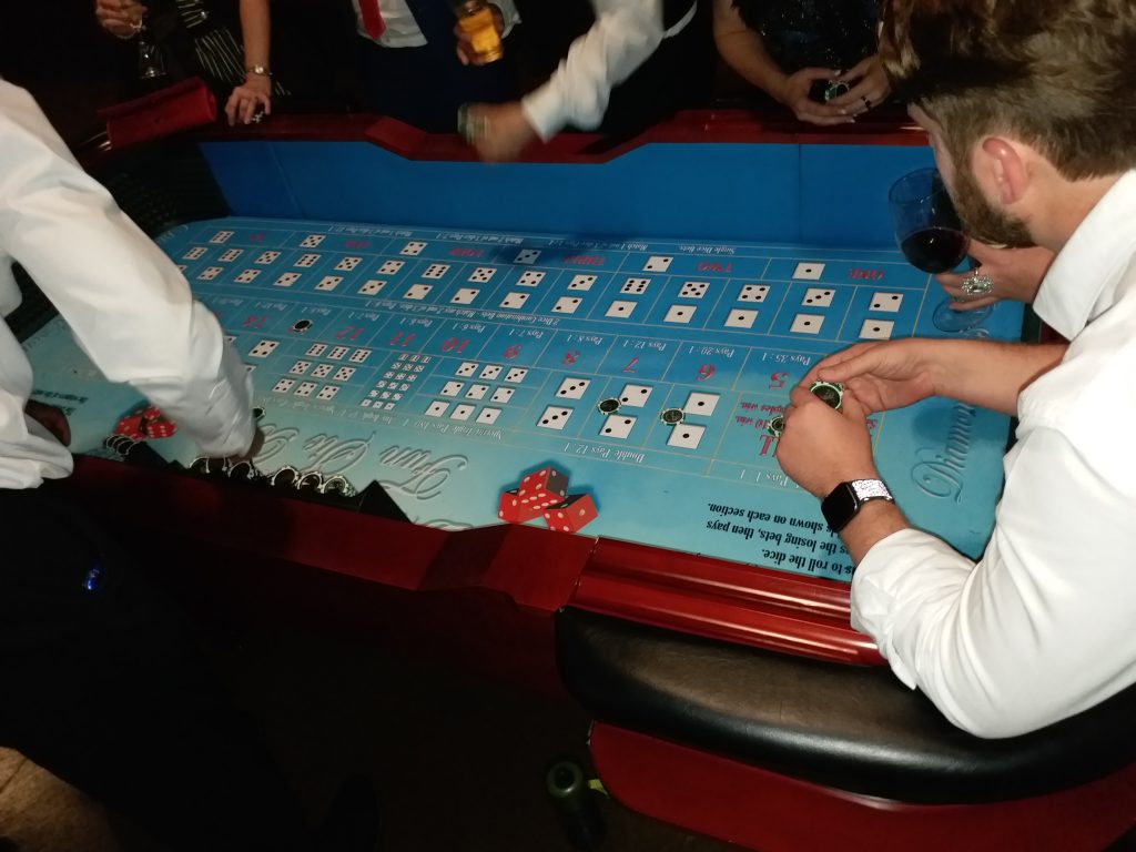 Professional craps table gaming at Wild Diamonds Fun Casino Brisbane event - Guests in formal attire enjoying luxury casino entertainment for Sunshine Coast and Brisbane corporate and social events