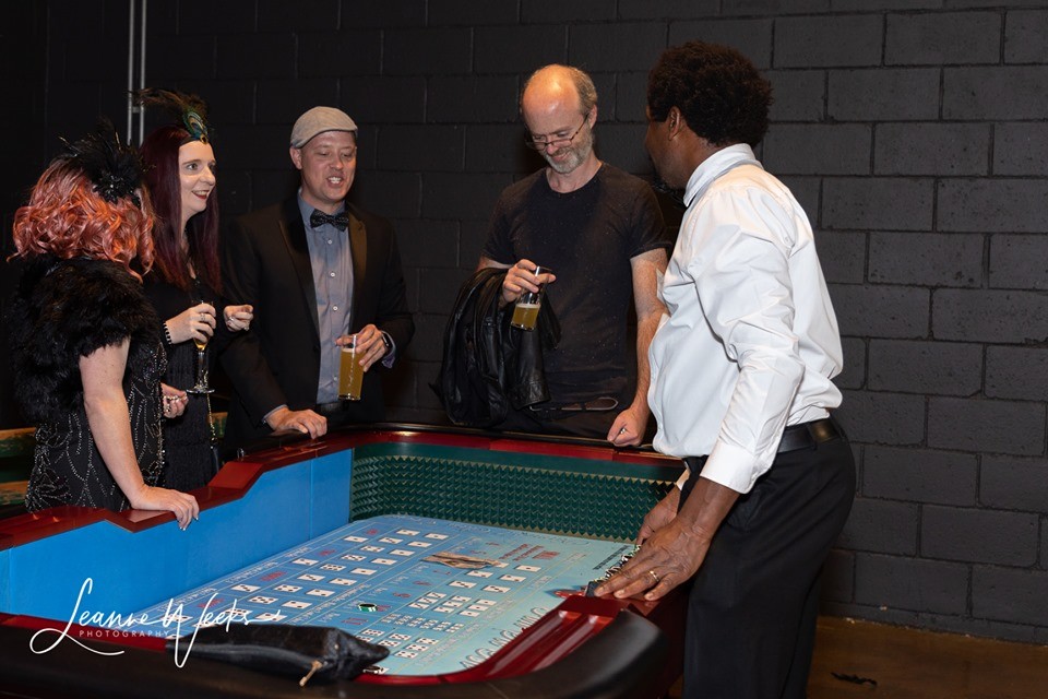 Social craps table gaming at Wild Diamonds Fun Casino Brisbane event - Guests mingling and enjoying casino entertainment for Sunshine Coast and Brisbane parties and celebrations